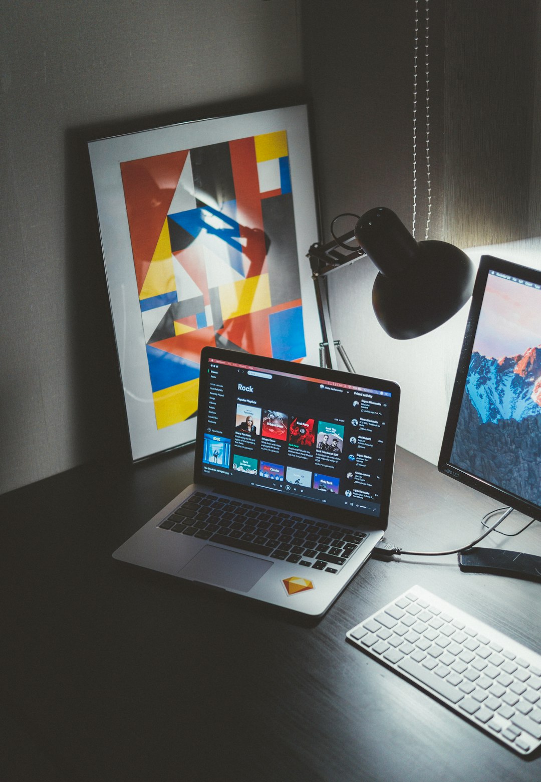 turned-on-macbook-on-table-beside-imac-g-yix8ynmny